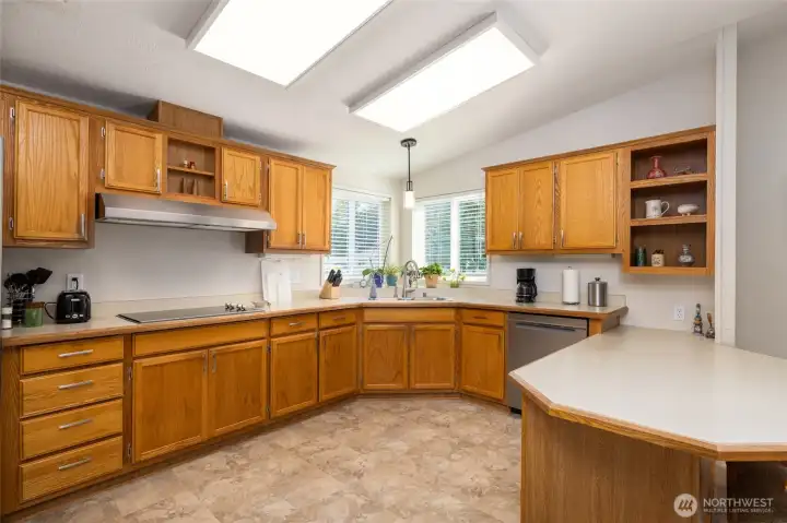 Spacious kitchen has been updated with new flooring, light fixtures and instant hot water