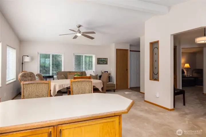 Looking into dining/living room with separate office space to the right