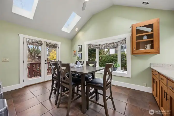 Tile floors, custom built in's and french doors are featured in the dining room.