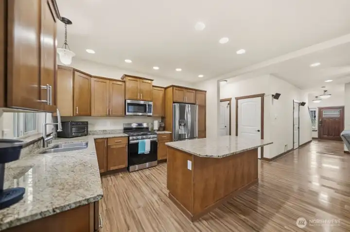 Open kitchen with granite counters.