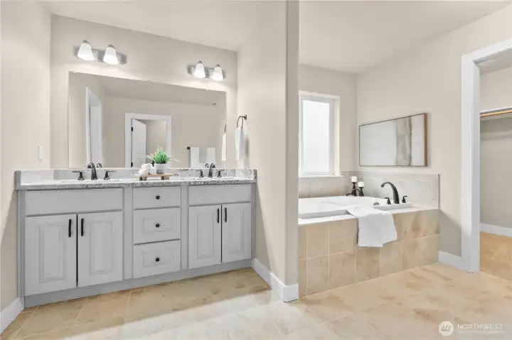 Primary's en-suite 5-piece bathroom with soaking tub, walk-in shower and walk-in closet