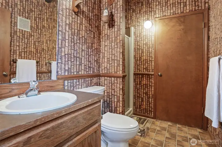 Pool bath room, includes a shower.  Notice the cool cork wall paper.