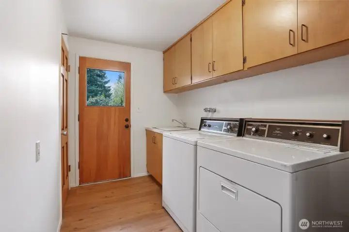 Large laundry room with lots of storage off the family room.