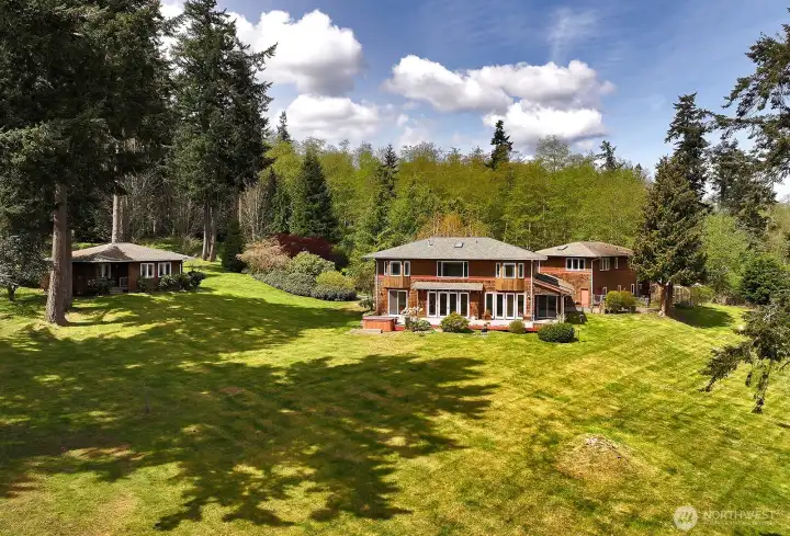 The three structures include the main residence, guest house and garage/shop with bonus rooms above.