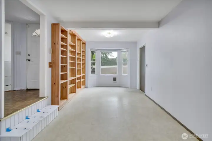 Family room with built-in cabinets and a bright bay window that fills the space with natural light.