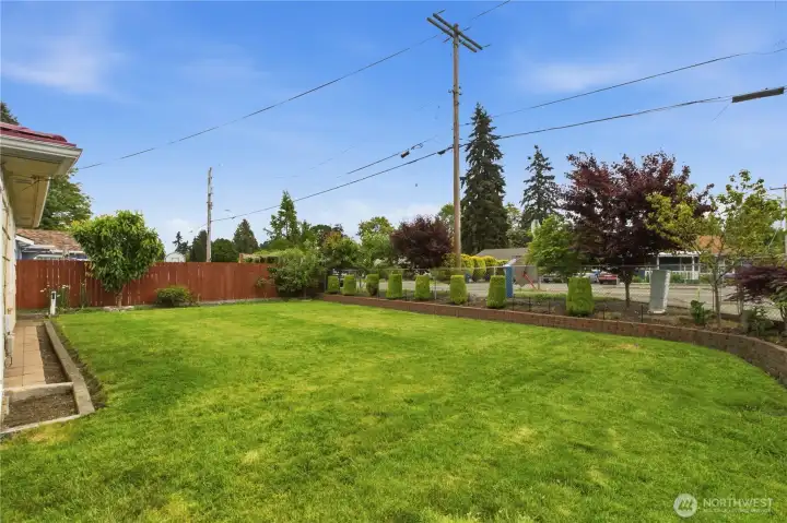 Situated on a spacious corner lot, the home features a beautifully manicured lawn that enhances its welcoming presence.