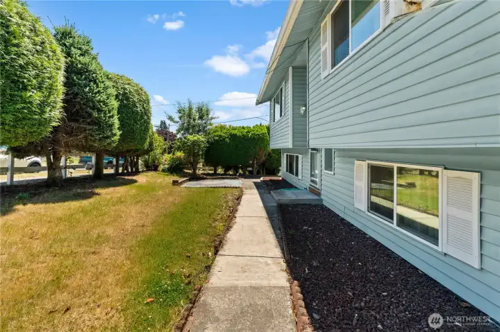 Front yard and walkway to front door and far side of home from driveway