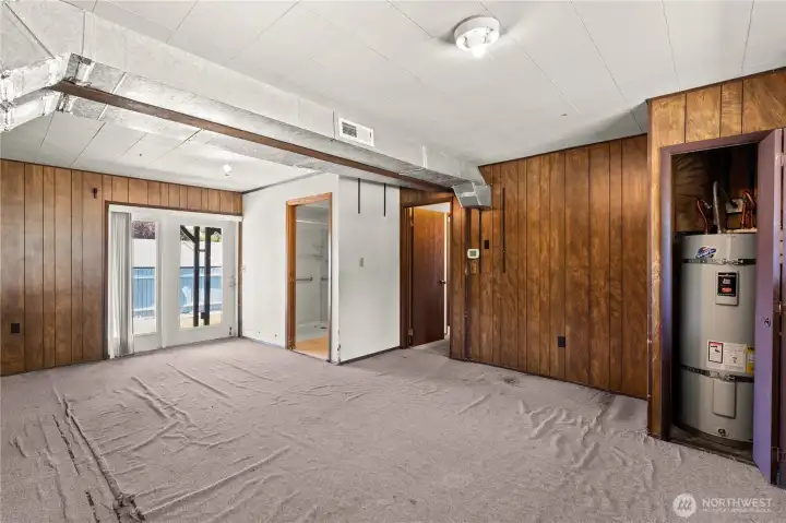 Lower level bonus room looking towards patio and bathroom that has a shower and sink