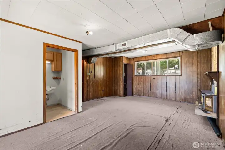 Lower level bonus room looking towards front of home and bathroom from backdoor slider