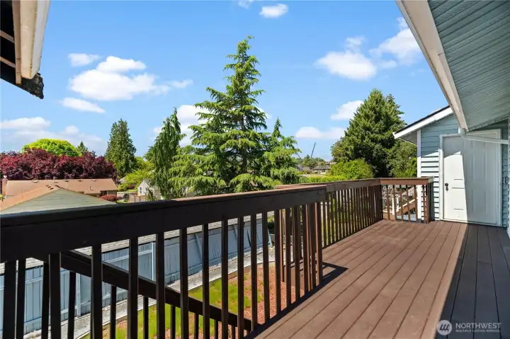 Deck that leads from upper back door slider to primary bedroom and 2nd floor storage