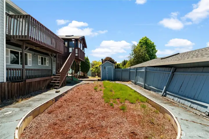 back of home (left), storage shed (foreward), and garage (left)