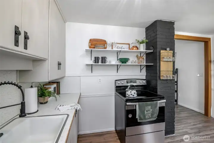 Open shelving and painted exposed brick add function and style  .