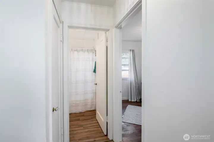 Hallway connects bath with 2 bedrooms & the water heater closet.