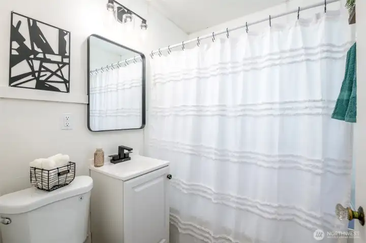 Refinished tub, new vanity, lighting, toilet, paint & LVP flooring.