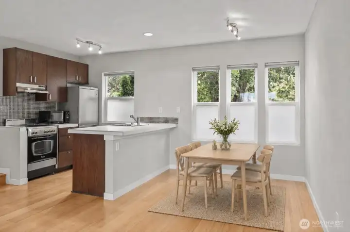 Nature right outside with mature trees and lots of natural light. Space at the breakfast bar, or room for table as well. (virtually staged)