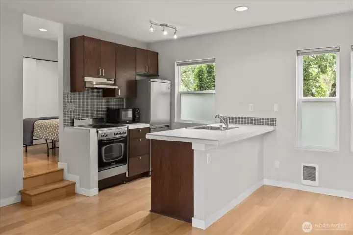 Open kitchen and large island counter. Separate bedroom/bathroom space up the stairs
