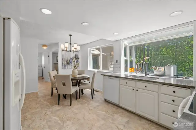 Light pours into the sizable kitchen with extra room for casual dining.
