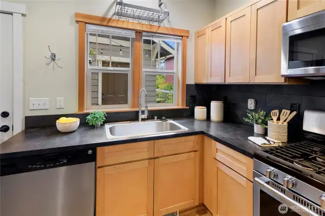 The kitchen includes a gas range, dishwasher, microwave oven and refrigerator.
