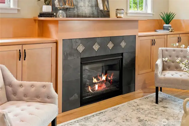 The fireplace is accented by craftsman tile.
