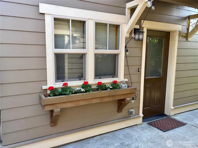 The kitchen window is accented by a pretty flower box.