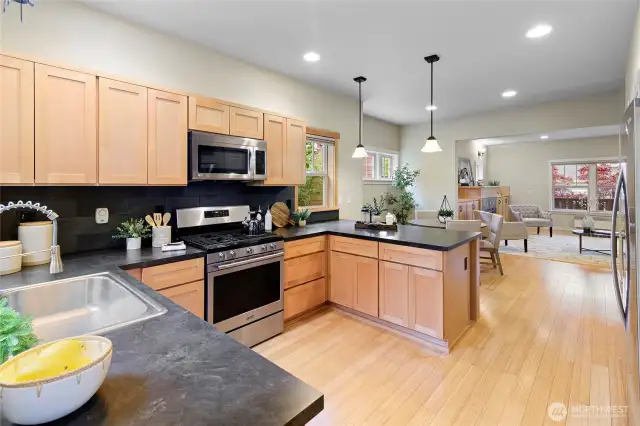 The kitchen features maple cabinets and stainless steel appliances.