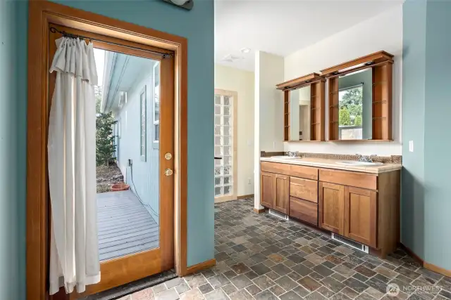 The ensuite primary bathroom has a door leading out to a private deck.