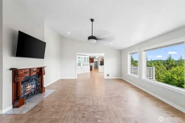 Living room with vaulted ceilings, huge windows, and two-way fireplace
