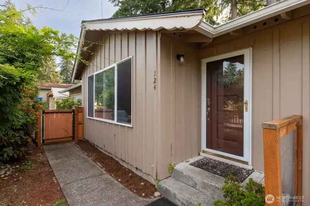 Fenced, paved walkway to your front door.