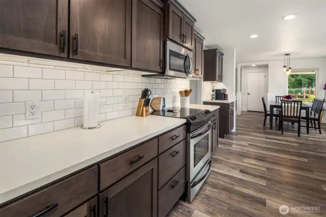 Modern updates include concrete countertops and open shelving