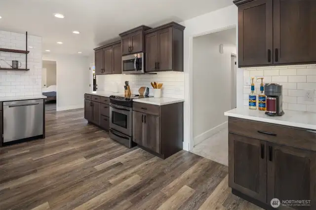 Large kitchen pantry is first door in hallway. Auto-lit. Hallway leads to 3 bedrooms and bath.