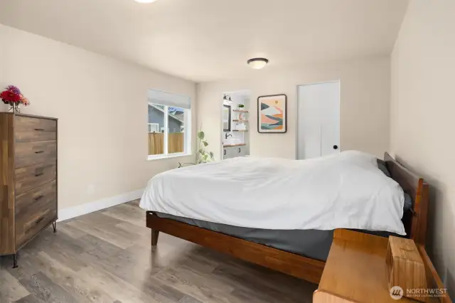 Primary Suite with a full bath, WIC, and French doors to the deck.