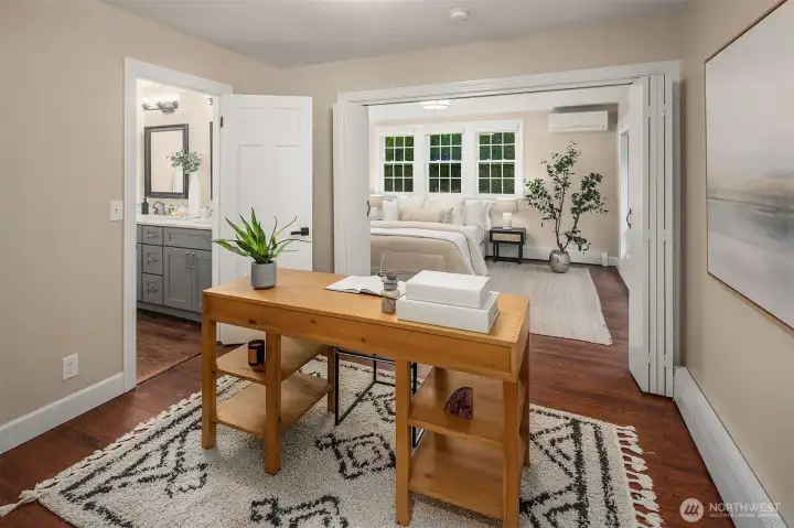 The second main floor primary suite offers an adjacent office or den.