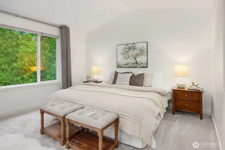 Primary bedroom with vaulted ceilings
