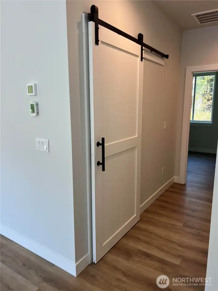 Barn Door leads to Utility Room & Garage Entrance.