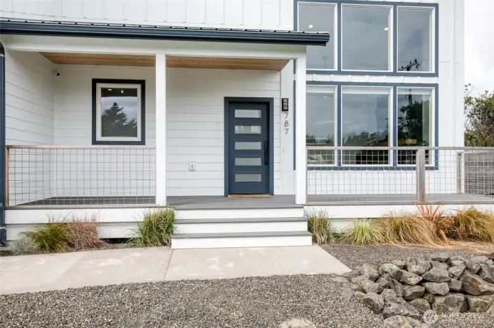 Inviting covered porch. Modern door with keyless door lock
