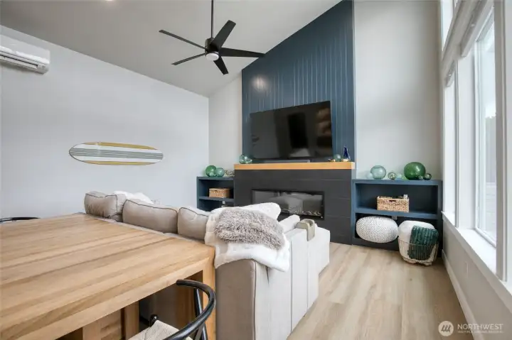 Bright, modern vibes with luxury vinyl plank flooring throughout, ceiling fan, electric fireplace and mini-split heat pump for year round comfort