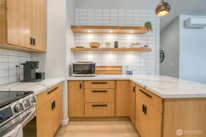 Stylish shelving and tons of cabinets and counterspace