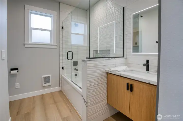 Primary bath with gorgeous floor to ceiling custom tilework