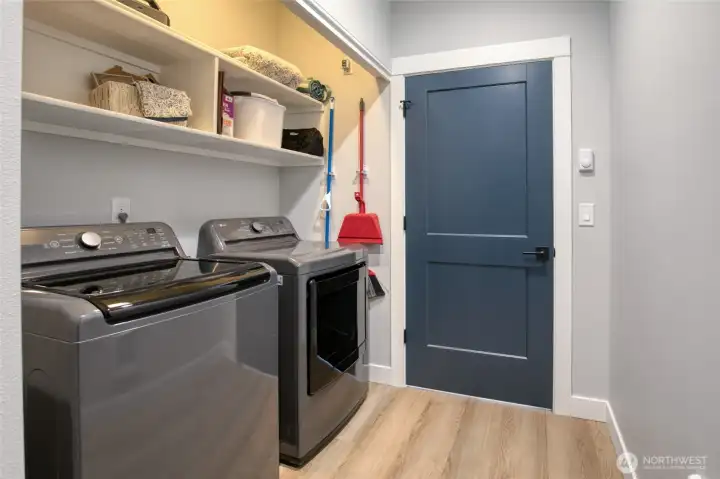 Utility room with built-in shelving. Washer and dryer stay!