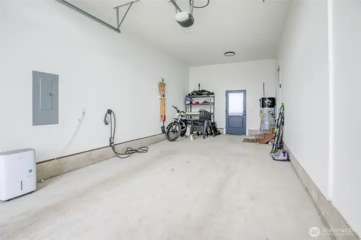 28' extra deep garage with EV charger, remote control garage door opener and door to the backyard