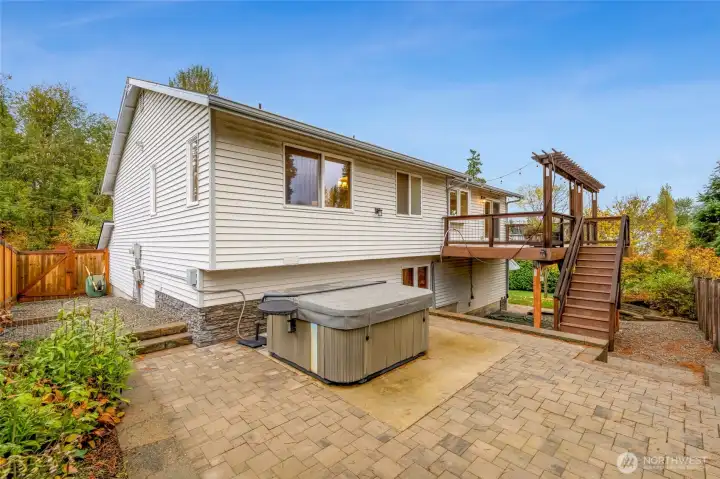 Paver patio with a private hot tub area and easy access to the deck above. Ideal for relaxing evenings or hosting friends outdoors.