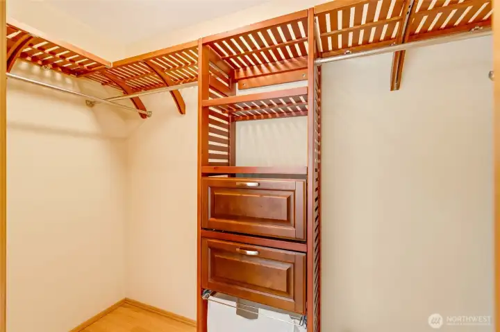 Custom closet system with built-in drawers, shelving, and double hanging space for efficient organization and storage.