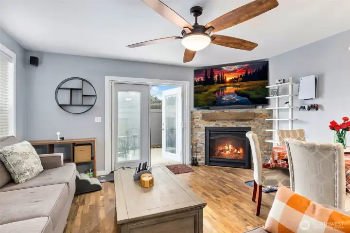 Living room with new double doors, ceiling fan and beautiful fireplace