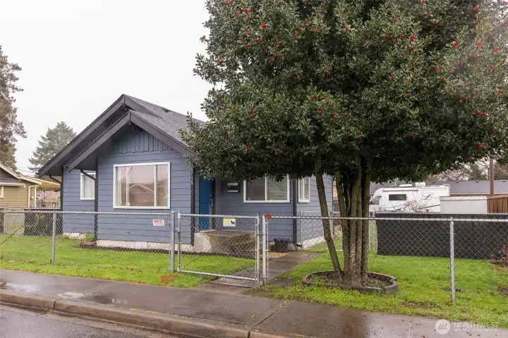 Front exterior with fenced yard.