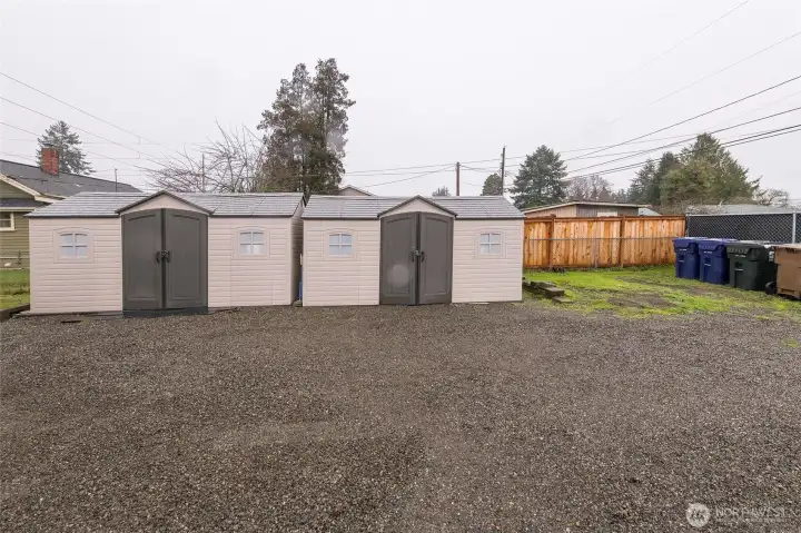 Two detached sheds offer convenient outdoor storage.