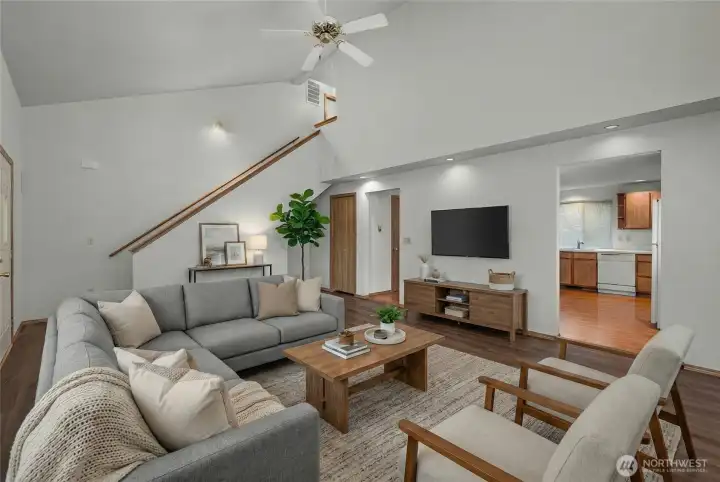Bright living room with functional layout, natural light, and easy flow into the kitchen and dining areas.