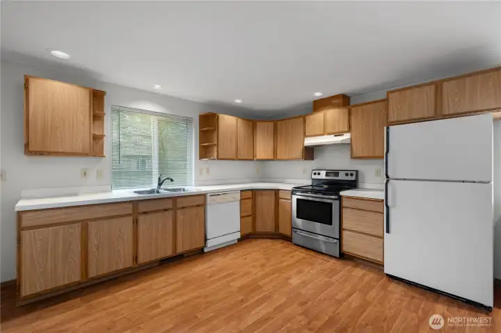 Efficient kitchen with ample cabinetry, counter space, and direct connection to the main living areas.