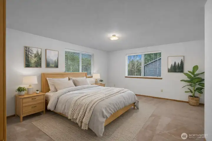 Comfortable primary bedroom featuring generous space, natural light, and convenient access to the home’s bathroom.