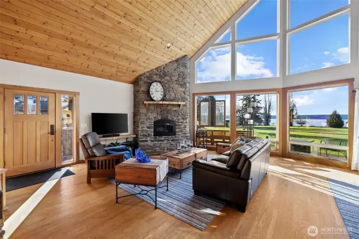 Welcome Home. As you enter, you are greeted with cathedral tongue and groove ceilings, hardwoods, sunshine, and light in the open concept living area.