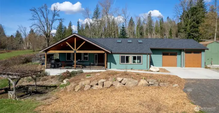 From wisteria to fruit trees, organic gardens to sheds galore, you'll enjoy this 5.42-acre canvas!